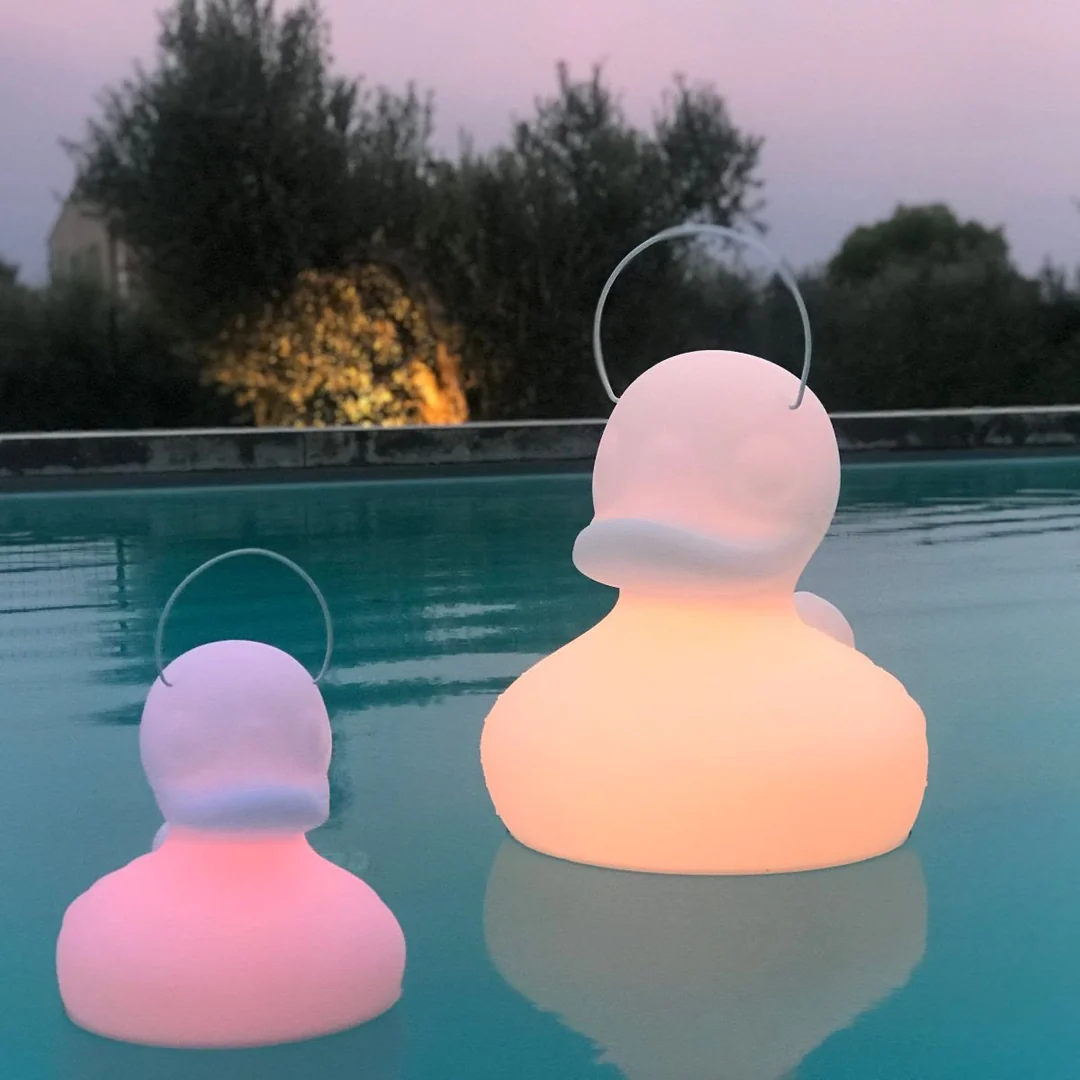 Goodnight Light Duck Duck Light floating in pool at dusk
