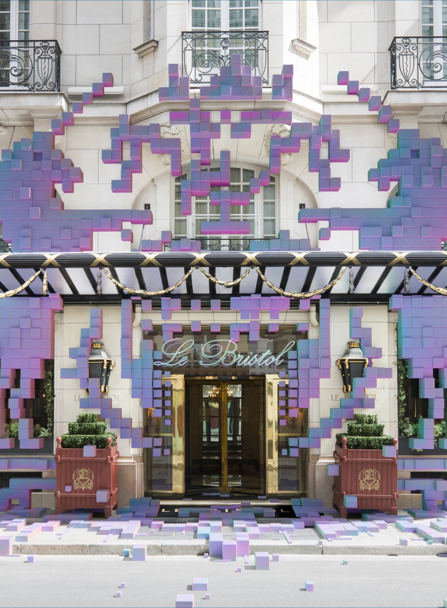 Le Bristol Paris façade with METAV.RS pixelated NFT overlay